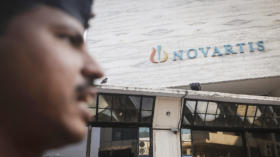 A security guard stands outside the Novartis headquarters building in Mumbai February 6, 2014. Global pharmaceutical firms ar